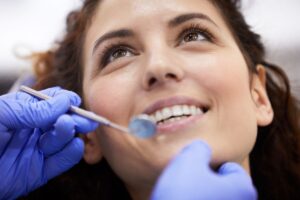 Dentist examining a patient's mouth during a routine dental checkup